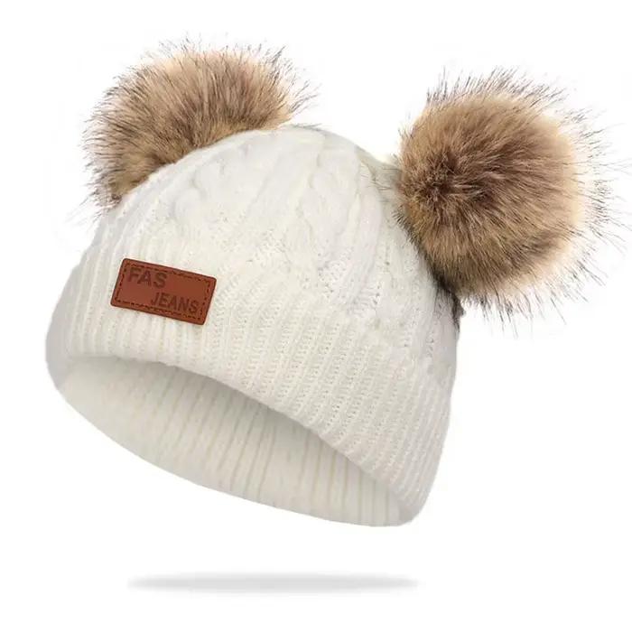 Bonnet double pompon en laine pour enfants