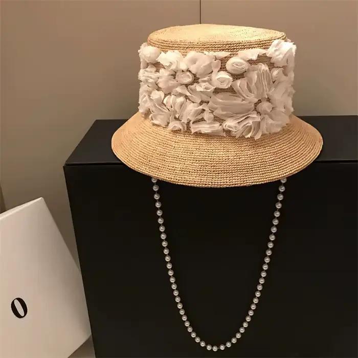 202606-hh5236A Nouveauté chapeau bob décontracté en raphia naturel avec ruban floral et chaîne de perles pour homme et