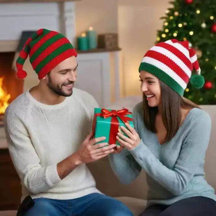 Chapeau de noël tricoté avec rayures rouges et vertes et boule de fourrure